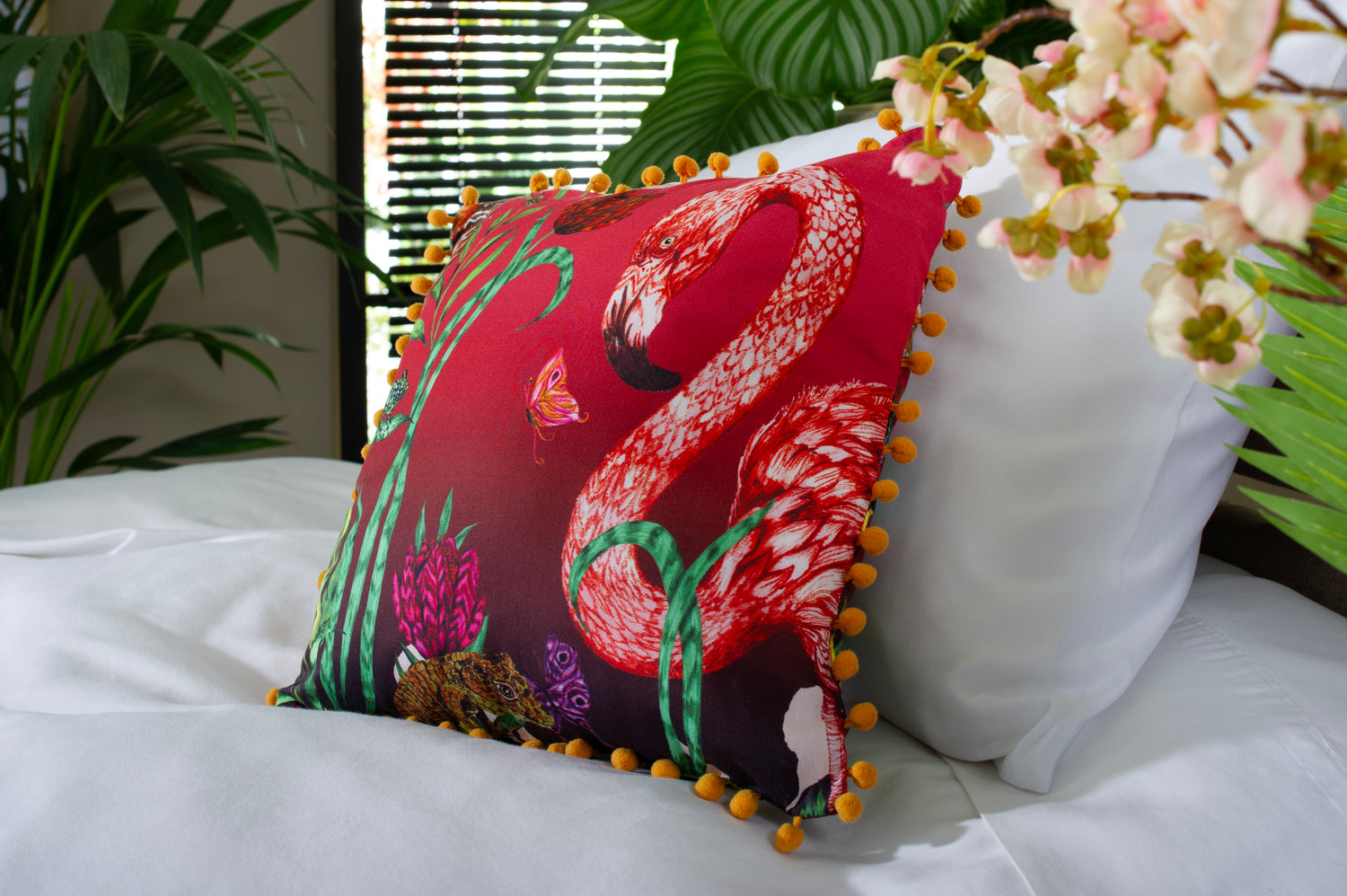 House of Norris exotic cotton bedding set with white bedlinen and colorful flamingo pillow on bed