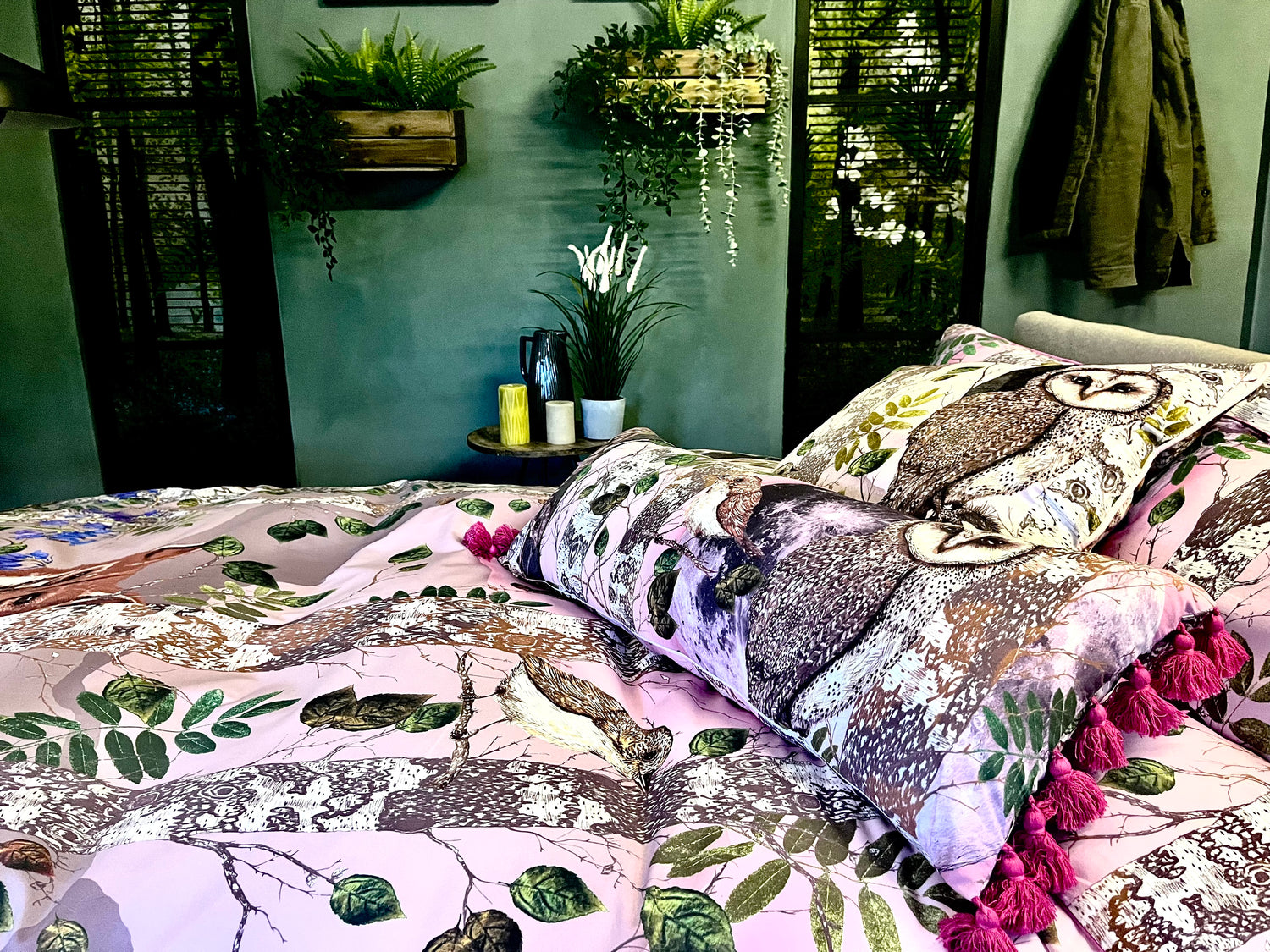 House of Norris forest theme cotton bedding set with owl and tree design on a bed with pink tassels